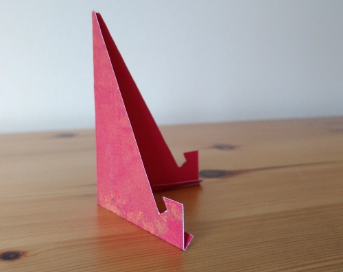 a small DIY stand made from red cardboard